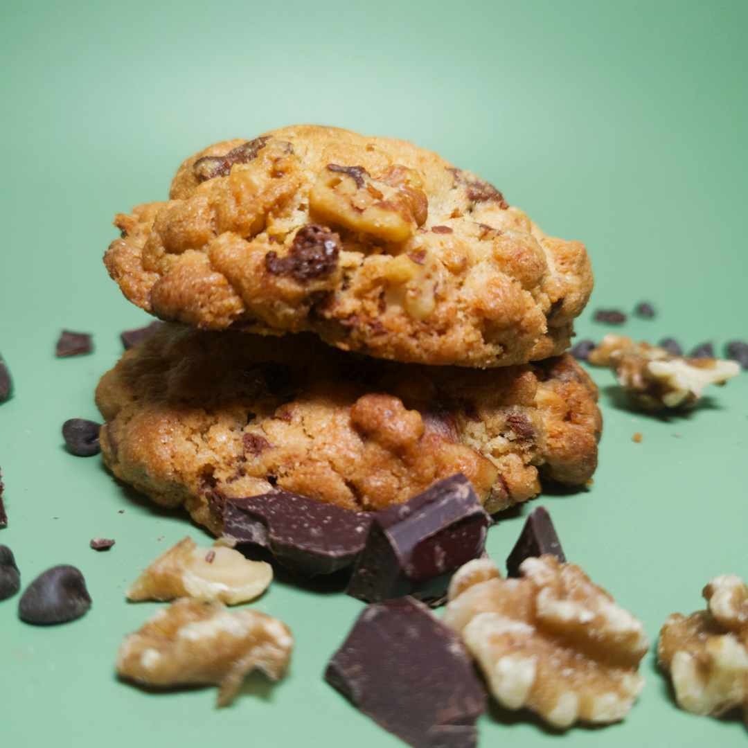 Two Chocolate and Walnut cookies close up mounted on each other