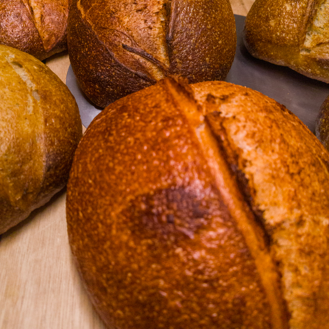 Close-up of a loaf of bread on a wooden surface.