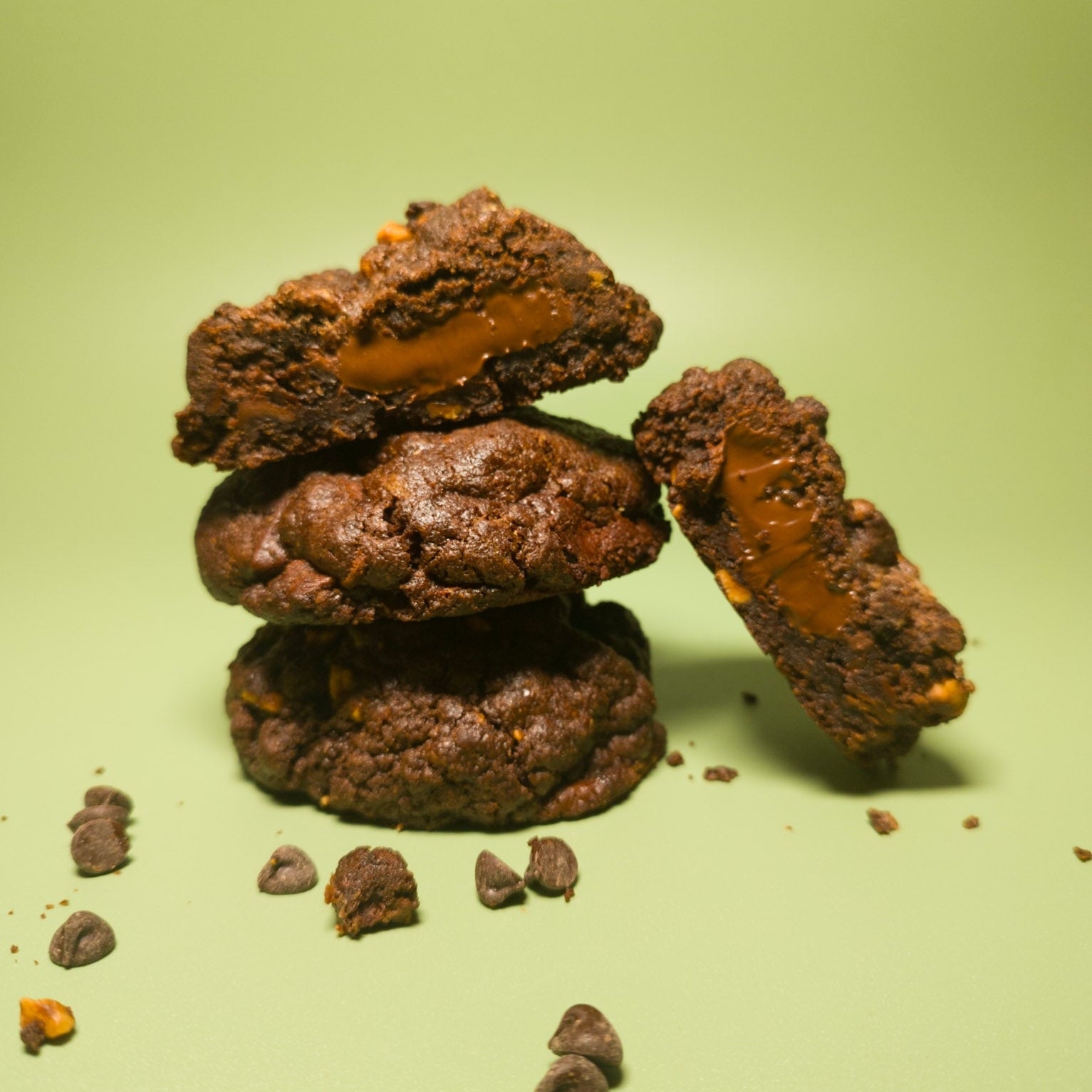 Stack of chocolate cookies with a green background